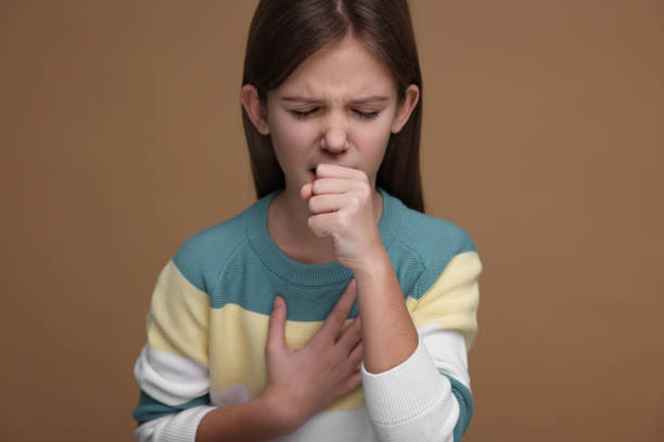 istock Sick girl coughing on brown background. Cold symptoms 2191427846