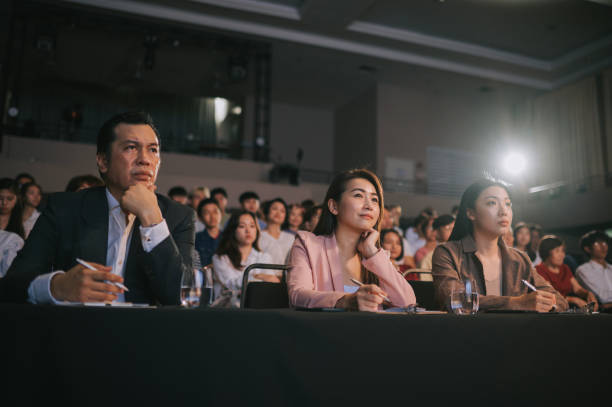 istock Asian panel judges listening giving score to stage performance competition in front of audience 2191428534