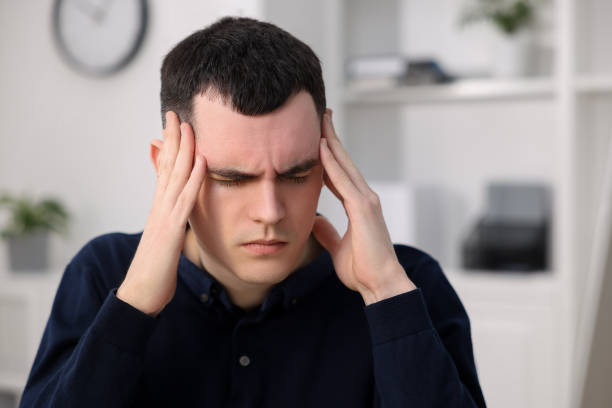 istock Young man suffering from headache in office, space for text 2191428679