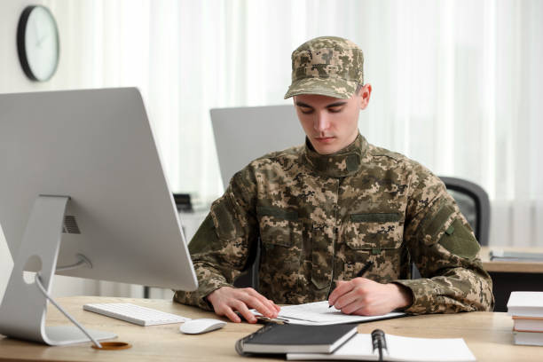 istock Military service. Young soldier working at wooden table in office 2191428706