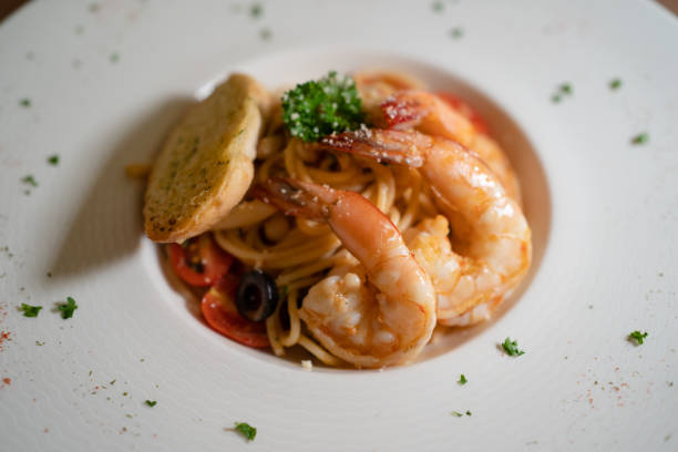 istock Spaghetti with tomato sauce, shrimp, bread, and cherry tomatoes. 2191429118