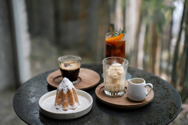 Sponge cake topped with icing sugar, served with black coffee. Coffee break concept. Cafe hopping concept.