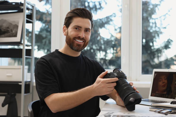 istock Professional photographer with digital camera at table indoors 2191429443