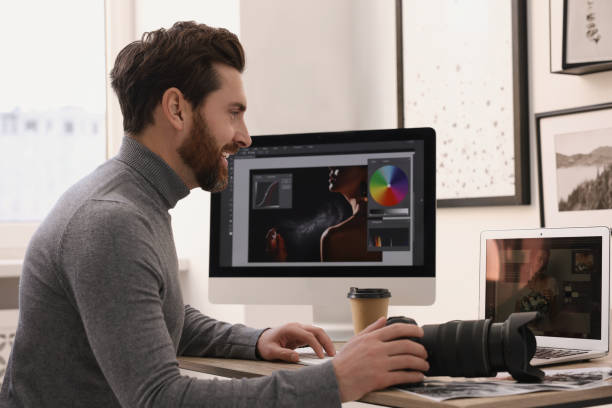 istock Professional photographer with digital camera at table in office 2191429500