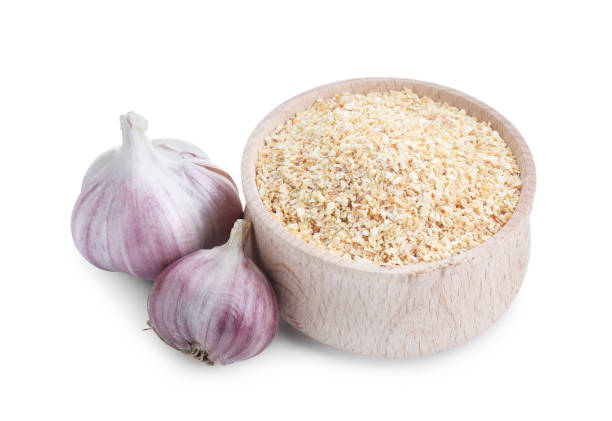 istock Dehydrated garlic granules in bowl and fresh bulbs isolated on white 2191432747