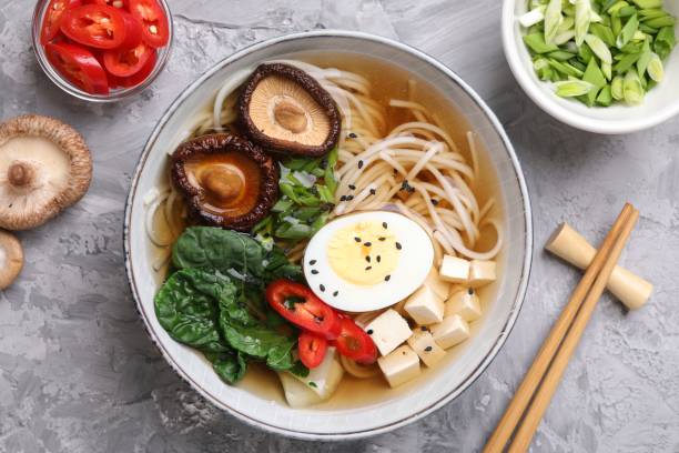 istock Delicious vegetarian ramen served on grey table, flat lay. Noodle soup 2191433816