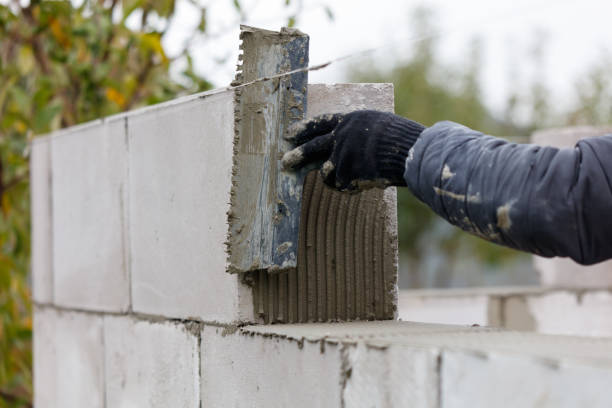 istock A person is laying bricks and using a trowel to spread mortar 2191434134