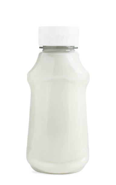 istock Fresh mayonnaise sauce in glass bottle isolated on white 2191434163
