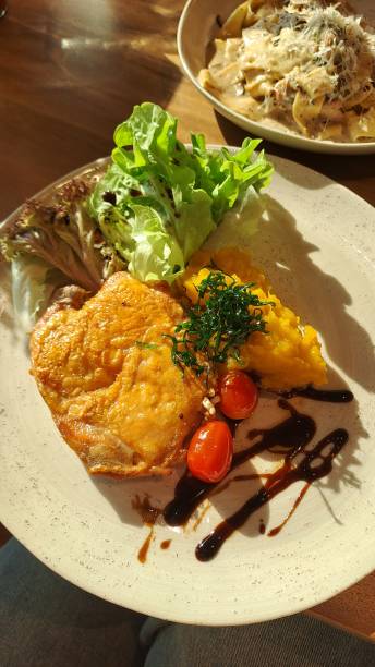 istock Grilled Chicken with Salad and Pumpkin Mash in Sunlit Setting at FAM time Restaurant (ONE BANGKOK Mall) 2191434921