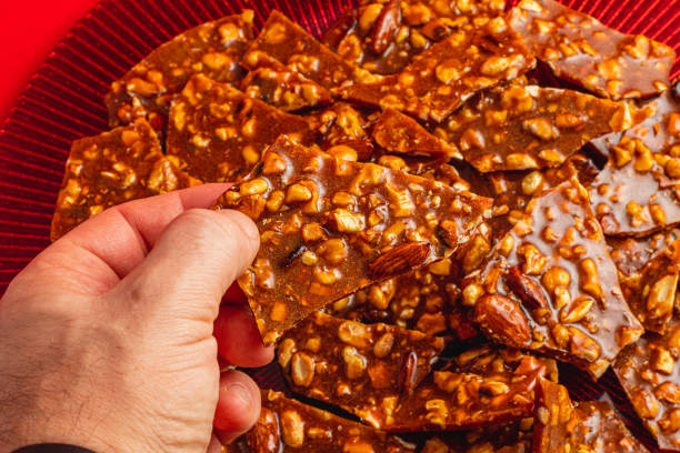 istock Homemade sugar gozinak with nuts in a man's hand 2191435287