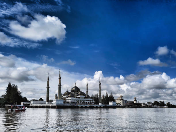 istock A stunning mosque with looms against a moody sky, reflecting on rippling waters. 2191435339