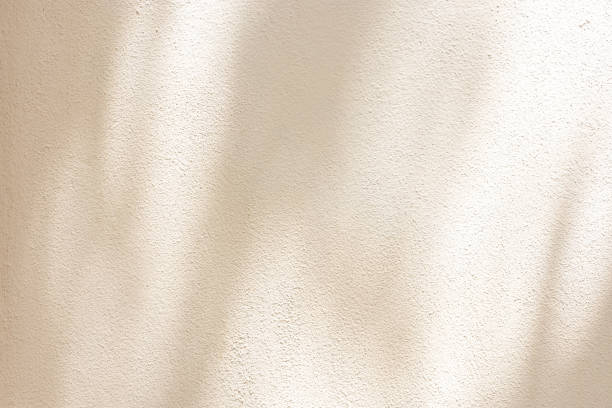 istock close up on beige plain wall background texture with shadow of window from sunlight for ads and advertisement product such as cosmetic or content or goods design display concept 2191436639