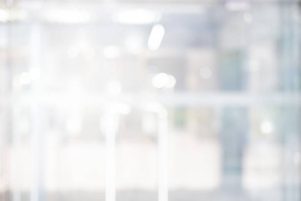 istock Abstract blurred inside interior of office building background with shine light for advertisement design and show content concept 2191436642