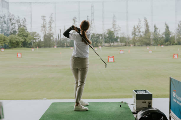 istock Passion for Golf: Young Player Taking a Swing on the Green 2191436838