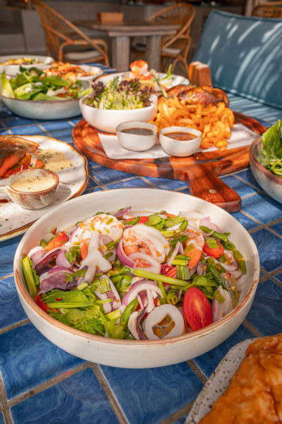 istock High angle, Spicy seafood salad in bowl on blue tiled surface, Thai dish 2191438427