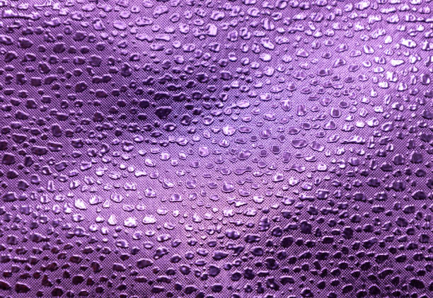 This image shows a full frame macro abstract texture background of a purple color embossed vinyl fabric background.