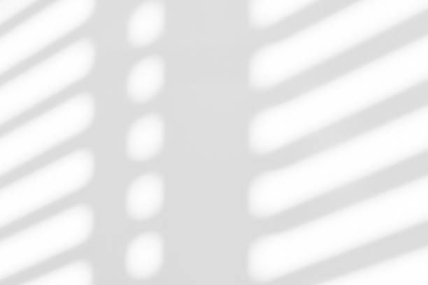 istock White wall with shadow of shutters window overlay. 2191440102