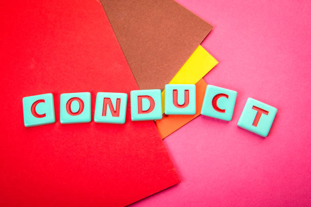 istock CONDUCT. Alphabet letter tiles on a red textured background 2191441838