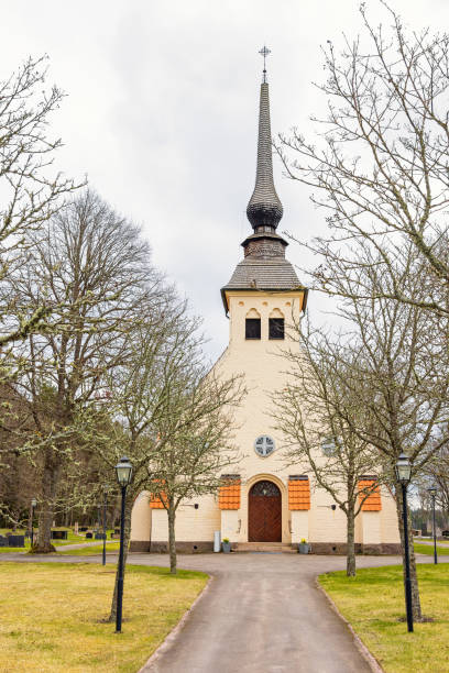 istock Tree lined walkway to a church in the countryside 2191443409