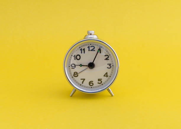 istock Vintage alarm clock on yellow background with copy space. 2191448081