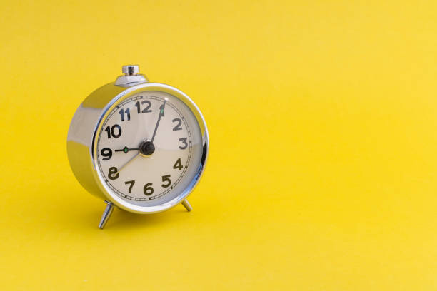 istock Retro alarm clock on yellow background with blank space for text. 2191448084