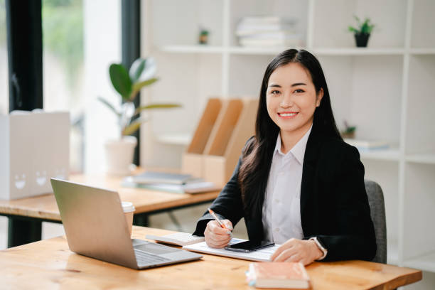 istock Asian business woman Working at the office with documents on the table Planning to analyze financial reports business plan investment financial analysis concepts 2191449024