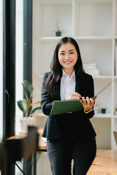 istock Asian business woman Working at the office with documents on the table Planning to analyze financial reports business plan investment financial analysis concepts 2191449110