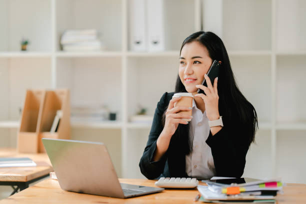 istock Cheerful businesswoman using smartphone to chat at office 2191449235