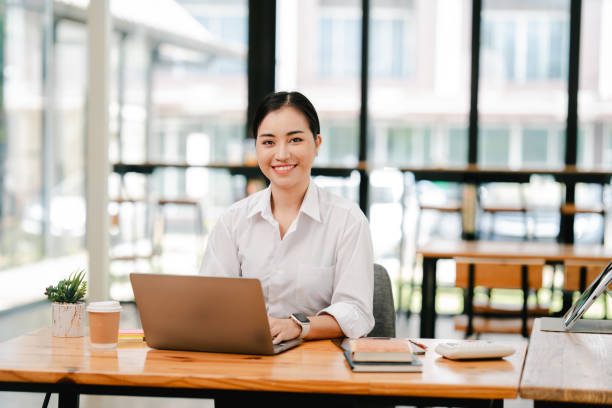 istock Asian female student studying online and taking notes. Female accountant doing annual financial and tax reports 2191449545