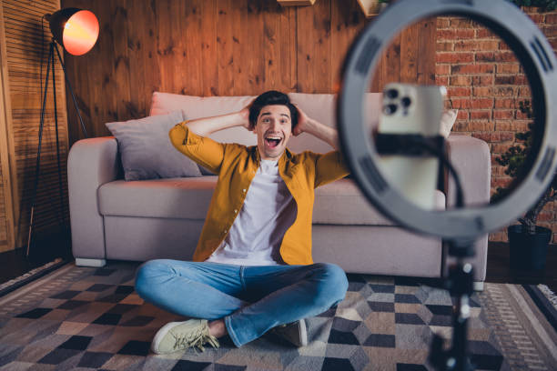 istock Young male enjoying a relaxed weekend at home while creating content in a stylish loft living room with cozy decor and natural daylight. 2191449580