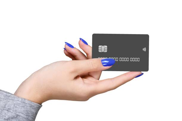 Hand holding black credit card with blue nails.