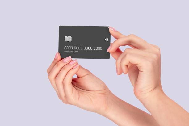 istock Hands holding a black credit card 2191452481