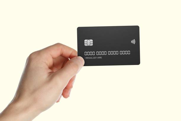 istock Hand holding a black credit card. 2191452493