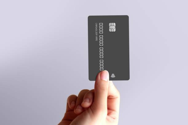 istock Hand holding a blank black credit card. 2191452500