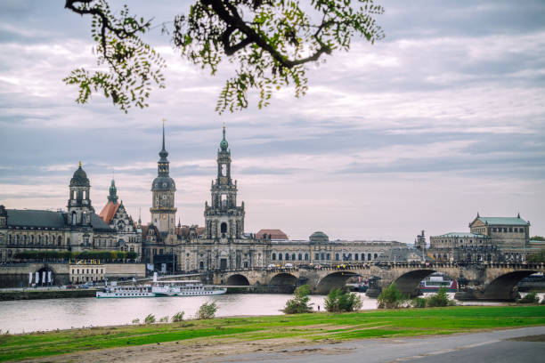 View of the historical buildings and landmarks in Dresden, Germany, showcasing stunning architecture by the Elbe River under a cloudy sky with scenic surroundings.