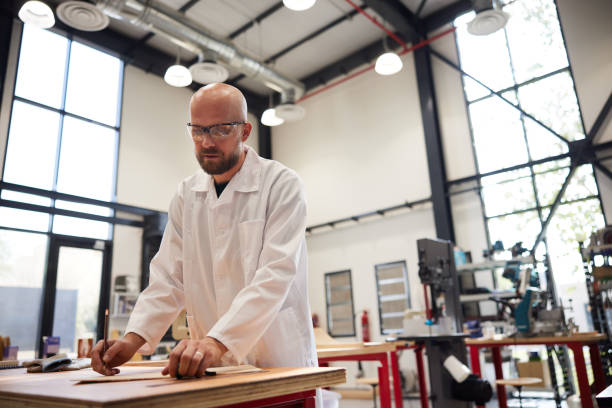 istock In a woodwork shop, a craftsperson measures precisely on a wooden board. 2191455967
