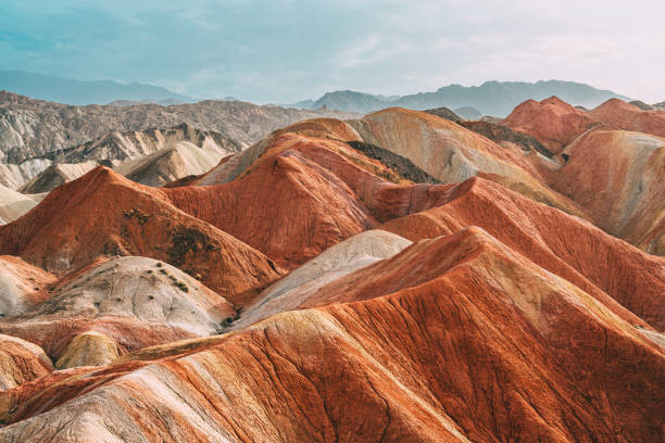 Zhangye Danxia National Geopark Zhangye Danxia National Geopark, Gansu, China. Colorful landscape of rainbow mountains. Walking paths around sandstone rock formation at Zhangye National Geological Park. zhangye danxia geopark china stock pictures, royalty-free photos & images