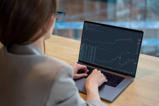 istock Businesswoman Analyzing Financial Graphs on Laptop in Modern Office Setting 2191457479
