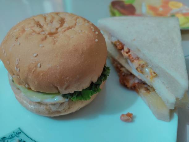 istock Hamburger and cheese sandwich on white plate with copy space. 2191458709