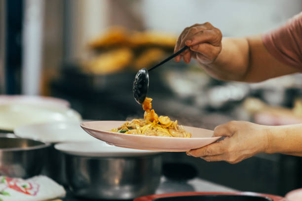 istock A woman is serving asian food. 2191458743