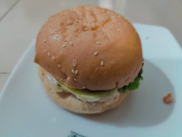 istock Hamburger on a white plate. Close-up shot. 2191458828