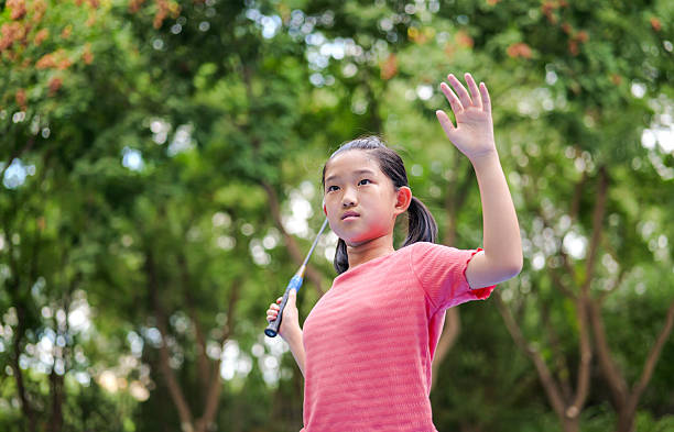 Little girl play badminton