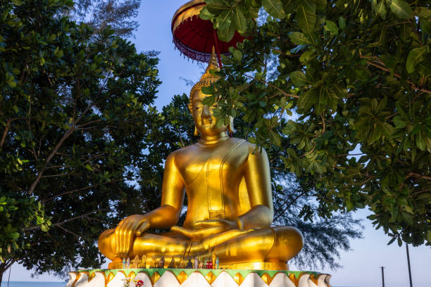 Golden Big buddha statue and lake at sunset in thailand
