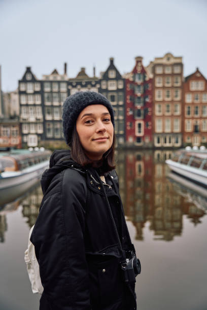 istock Young woman exploring amsterdam canals with a camera 2191459417