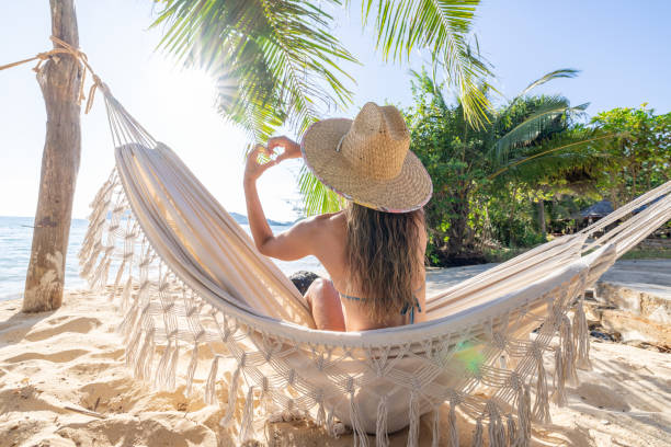 istock Woman Relaxing in Hammock on Tropical Beach 2191459565