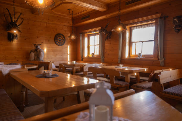 istock Rustic dining area featuring wooden tables and warm lighting in a cozy lodge setting 2191459974