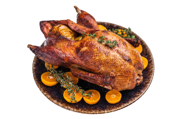 istock Roast goose with apples and oranges on plate with herbs isolated on white background. top view 2191460879