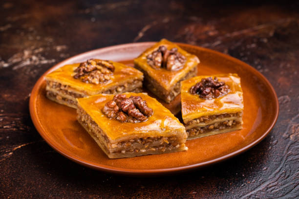 istock Delicious Honey Walnut Baklava on plate. brown background. top view 2191460910