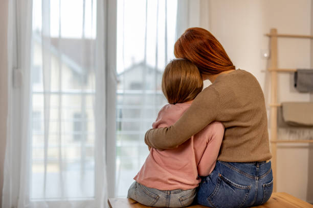 istock Mother Comforting Daughter by Embracing Her in a Home Setting 2191463295