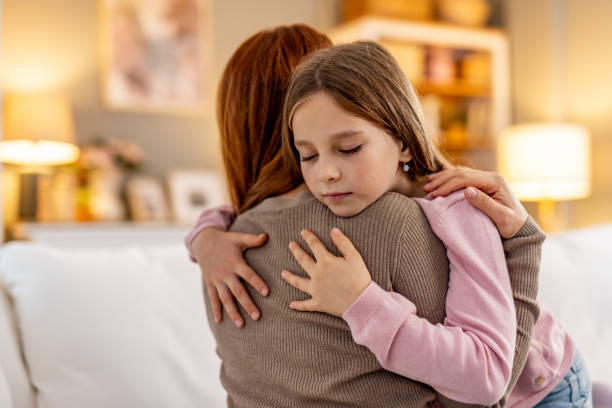 istock Mother Embracing Her Daughter in a Warm and Cozy Home Setting 2191463756
